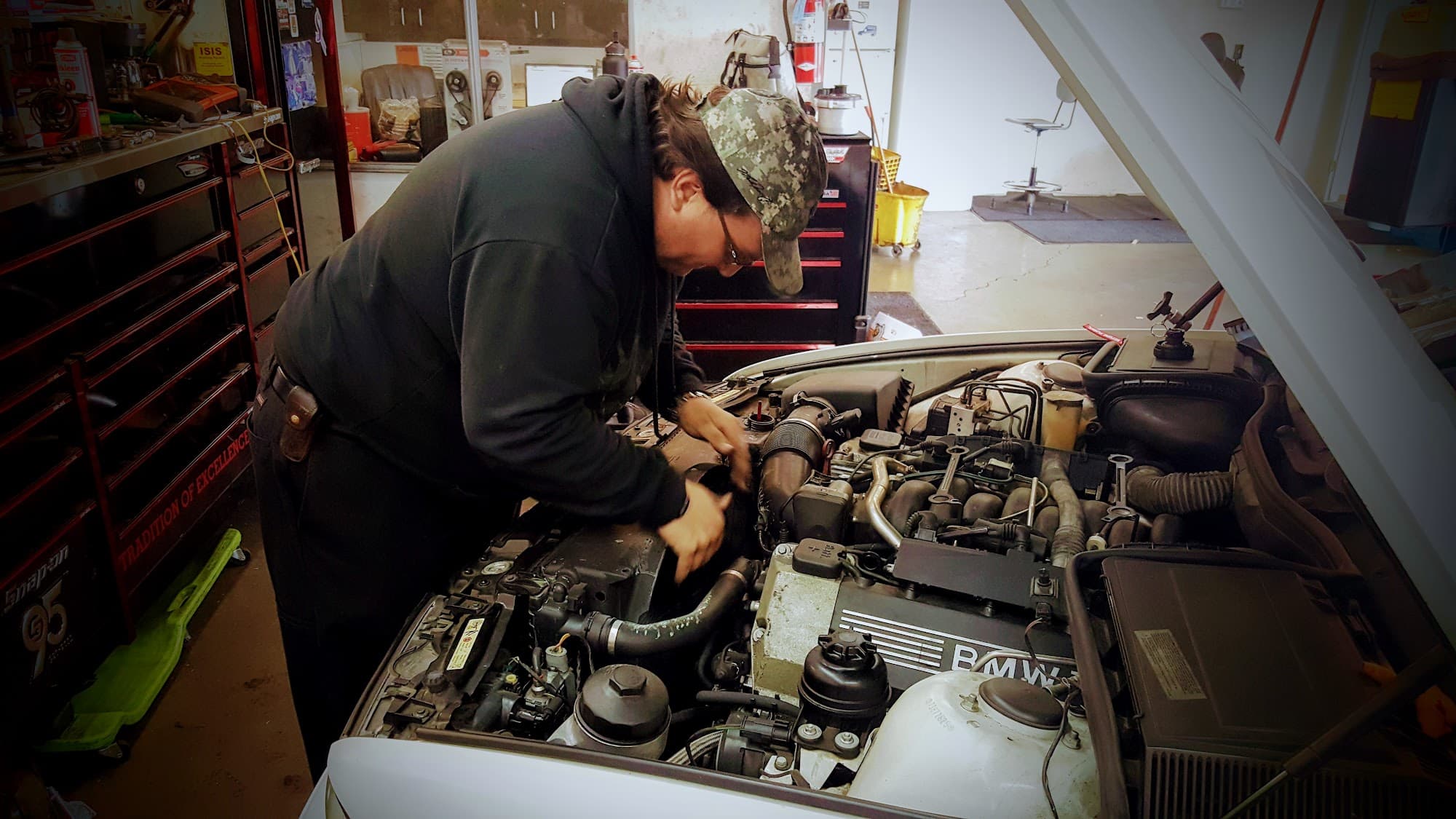 Sofiane Zemmouche inspecting vehicle at Tri-Valley Automotive
